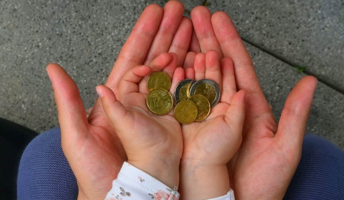holding coins in hand for the future
