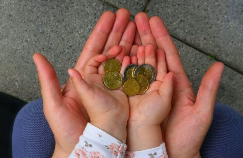 holding coins in hand for the future