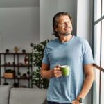 Middle aged man drinks coffee