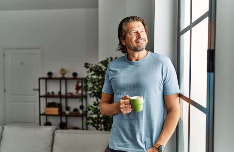 Middle aged man drinks coffee